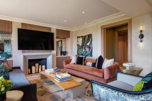 a living room with two couches and a fireplace at JW Marriott Essex House New York in New York