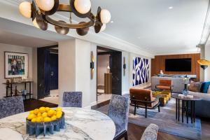 a living room with a table with oranges on it at JW Marriott Essex House New York in New York