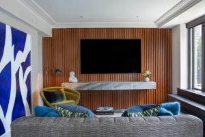 a living room with a couch and a television at JW Marriott Essex House New York in New York
