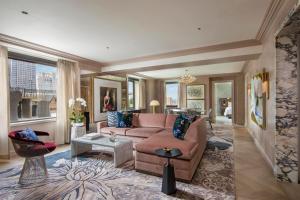 a living room with a couch and a table at JW Marriott Essex House New York in New York