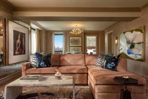 a living room with a brown couch and a table at JW Marriott Essex House New York in New York