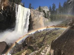 a rainbow in front of a waterfall at Morning Star Vista near Yosemite - countryside with mountain views in Mariposa