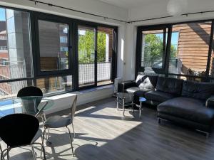 a living room with a couch and a table and chairs at Mordern Apartment in City Center in Manchester