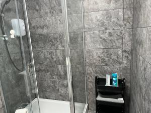 a bathroom with a shower with a toilet and a sink at Mordern Apartment in City Center in Manchester