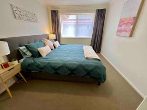 a bedroom with a large bed and a window at Sandstone Point and Bribie Beaches in Sandstone Point