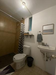 a bathroom with a toilet and a sink at Loft atardecer in Uruapan del Progreso