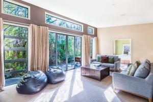 a living room with a couch and a table at Bush House - Lake Tekapo in Lake Tekapo
