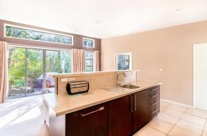a kitchen with a sink and a large window at Bush House - Lake Tekapo in Lake Tekapo