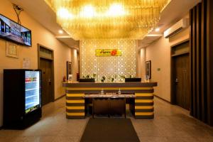 a bar in a lobby with a large chandelier at Super 8 by Wyndham Solo in Solo