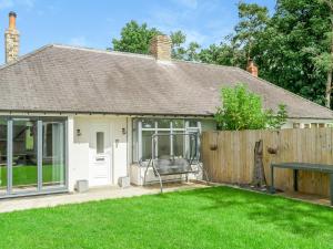 a house with a patio and a fence at Vallum Villa - Uk40231 in Bardon Mill