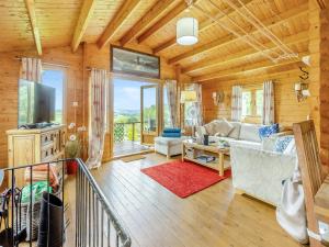 a living room with a couch and a tv at The Cabin Cefn Mawr in Highgate