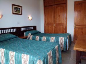 A bed or beds in a room at Apartamentos Los Aguacates