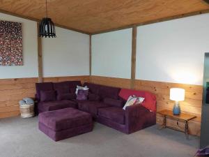 ein Wohnzimmer mit einem lila Sofa und einem Tisch in der Unterkunft The Barn in Westport