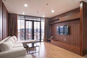a living room with a white couch and a tv at Apartment 1994 Đà Lạt center in Da Lat