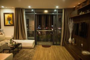 a living room with a couch and a large window at Apartment 1994 Đà Lạt center in Da Lat