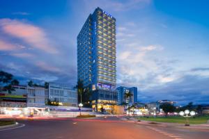 a tall building in a city at night at Xavia Hotel in Nha Trang
