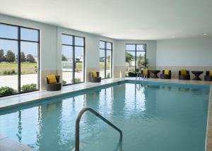 a pool in a hotel with windows at Staybridge Suites - Flowood - NW Jackson by IHG in Flowood