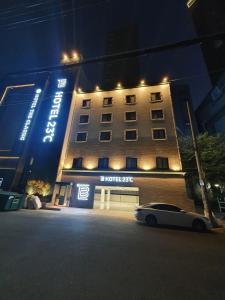 a car parked in front of a hotel at night at Hotel 23 in Ulsan