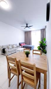 a living room with a wooden table and chairs at Beacon2BR #InfinityPool #Georgetown #FamilyHoliday in George Town