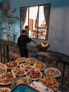 stół z wieloma talerzami jedzenia w obiekcie BlueHome Villa w mieście Hòa Bình