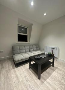 a living room with a couch and a coffee table at Home-like 1-BR flat in Victoria in London