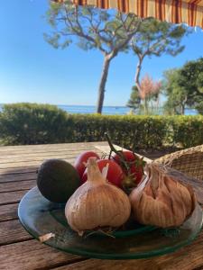 a plate of fruit and vegetables on a table at Villa Cannes directly on the sea in Cannes