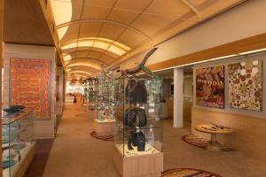 a store hallway with a large ceiling with glass shelves at Sails in the Desert in Ayers Rock