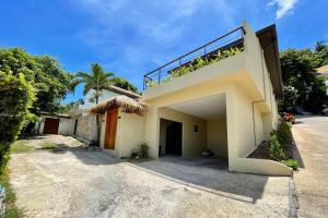 a white house with a balcony on top of it at Villa Marie, 2 Bedrooms, Lamai Koh Samui in Koh Samui 