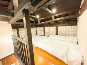 two beds in a room with wooden ceilings at One Night, One View, Lifelong Marriage, Yotsukaido - Vacation STAY 12735 in Yotsukaidō