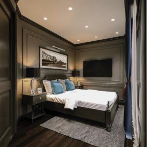 a bedroom with a bed and a flat screen tv at Casa Dos Príncipes Hotel & Spa in Hanoi +28 photos