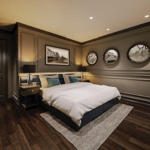 1 dormitorio con 1 cama grande y 2 relojes en la pared en Casa Dos Príncipes Hotel & Spa, en Hanói