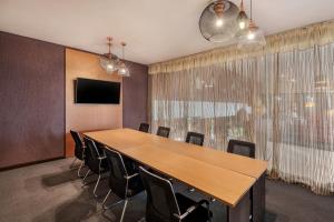 a conference room with a large wooden table and chairs at Protea Hotel by Marriott Ndola in Ndola