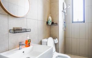 a bathroom with a sink and a toilet and a mirror at Platz @ KL North Setapak by Airhost in Kuala Lumpur +33 photos