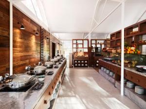 a large kitchen with many pots and pans on the counters at Desert Gardens Hotel in Ayers Rock
