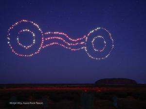 a group of lights in the sky at night at Desert Gardens Hotel in Ayers Rock