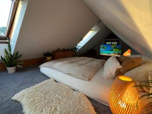 a bedroom with a bed in the attic at Bali-Style Tinyhaus am Wald in Bruckberg