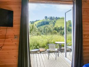 a room with a balcony with a sliding glass door at Creyr Glas Pod -uk41796 in Hirnant