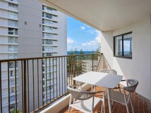 a balcony with a white table and chairs at Horizons Holiday Apartments - OFFICIAL in Gold Coast
