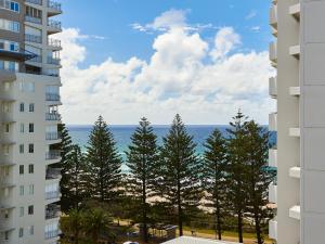 a view of the ocean from between two buildings at Horizons Holiday Apartments - OFFICIAL in Gold Coast