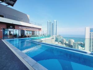 a large swimming pool on the roof of a building at Bona Elbon Haeundae Beach Ocean view in Busan