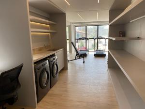 a laundry room with a washer and dryer at Bela Hospedagem - #Neo Duos 104 in Cabedelo