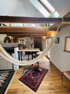 a hammock in a living room with a table at Bali-Style Tinyhaus am Wald in Bruckberg