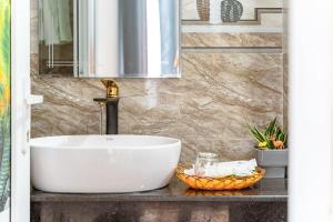 a bathroom with a white sink and a mirror at Villa Hẻm Đà Lạt in Da Lat