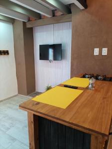 a large wooden table with a tv on a wall at MAJITO Rest&dream in Goya