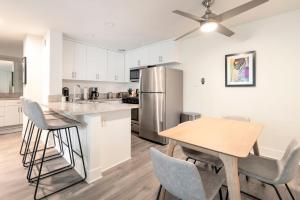 a kitchen with a table and chairs and a refrigerator at New Luxury Apartment WeHo Boys Town in Los Angeles