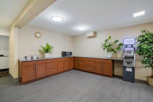 a large kitchen with wooden cabinets and a cash register at Americas Best Value Inn Fargo in Fargo