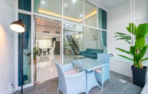 a dining room with a glass table and chairs at Patio Pool Villa in Gyeongju