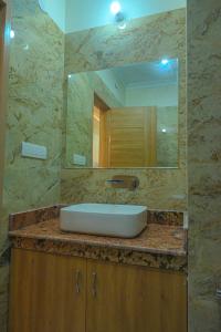 a bathroom with a sink and a mirror at HOTEL VIEW in Govardhan