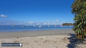 a bunch of boats in the water on a beach at Sealark in Callala Bay