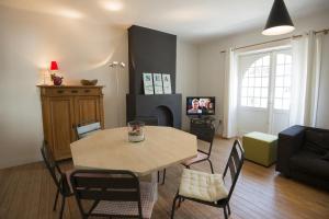 a living room with a table and chairs and a couch at Clos Normand in Nieuwpoort